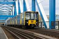 An image of a Metro train going over the Queen Elizabeth II Metro Bridge.